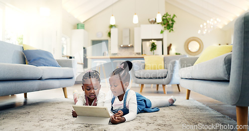 Image of Black girl children on ground with tablet and relax, elearning or watch cartoon movie, sisters at home and screen time. Young female kids, streaming online and subscription to education app or film