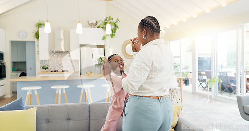 Image of Excited mom, child and dancing in living room with happiness, energy and bonding in home together. Black family, mother and daughter dance on sofa, music and quality time for woman and little girl.