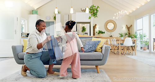 Image of Talking, happy and a mother with a child getting ready for school in the morning. Kiss, laughing and an African mom helping a little girl with a bag in the living room of a house for kindergarten