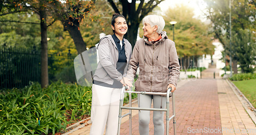 Image of Senior woman, walker and nurse outdoor in a park with healthcare for elderly exercise. Walking, healthcare professional and female person with peace and physical therapy in a public garden with carer