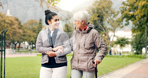 Image of Senior woman, walker and nurse talking in a park with healthcare for elderly exercise. Walking, healthcare professional and female person with peace and physical therapy in a public garden with carer