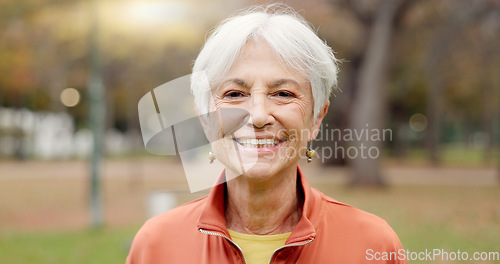 Image of Senior woman with a smile, portrait in the park and happiness in nature, woods or outdoor for a walk in retirement. Happy, face and elderly person with wellness from exercise or healthy workout