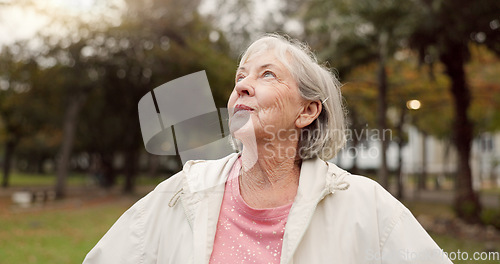 Image of Senior woman, thinking and outdoor at the park to breathe fresh air in nature or woods on walk in retirement. Happy, face and elderly person with wellness, happiness and positive mindset or gratitude