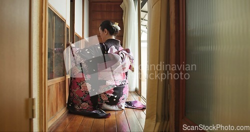Image of Open door, Japanese woman and culture with kimono, respect and relax in traditional accommodation. Morning, home and kneel at a window with zen, calm and ancient architecture with antique dress