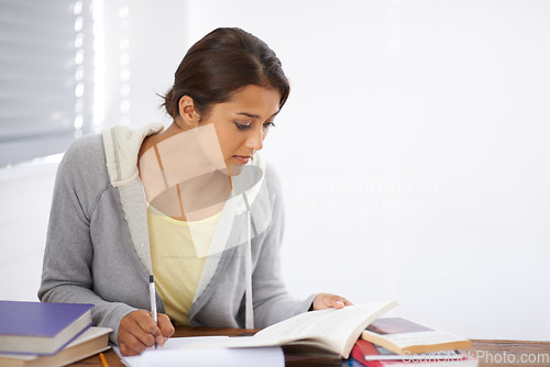 Image of Student, woman and writing with books for study, knowledge or education with notes for project in dorm room. Young person, girl and learning at desk with novel for scholarship, reading and assessment