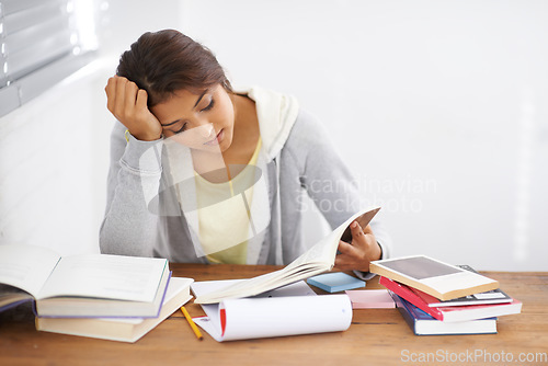 Image of Student, woman and reading with books for learning, knowledge or education with idea for study in bedroom..Young person, girl and stress at desk with novel for scholarship, project or assessment test
