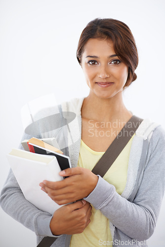 Image of Portrait, student and woman with books in studio isolated on a white background. Face, textbook and young person in university for education, knowledge or learning in college on scholarship in Brazil