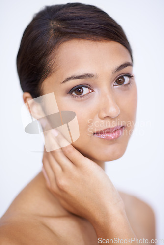 Image of Portrait, cosmetics and woman with skincare, dermatology and grooming on a white studio background. Face, Indian person and model with shine and soft with healthy skin, smooth and aesthetic with glow