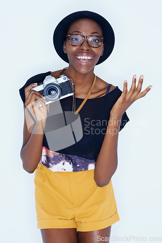Image of Black woman, photographer and portrait in studio with happiness, creativity and camera for talent and creative artist career. Young person, smile and face for photoshoot and lens by white background