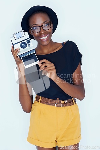 Image of Woman, photographer and portrait in studio with retro camera, creativity and happy artist with creative talent. African person, positive face or vintage film in photoshoot or lens by white background