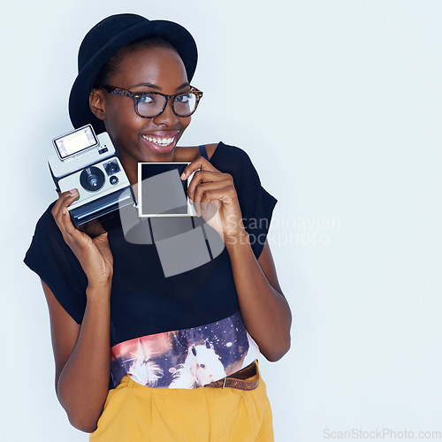 Image of Happy woman, polaroid and portrait in studio with camera, creativity and media for artist with creative talent. Young photographer, happiness and face by vintage image and focus by white background