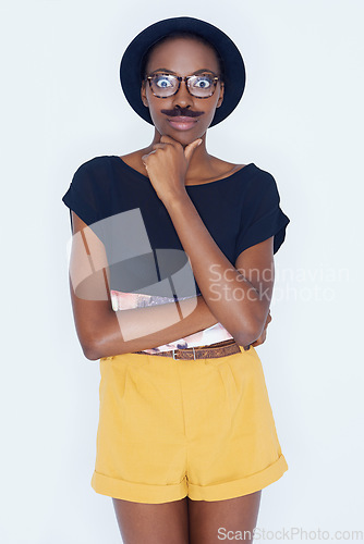 Image of Funny, portrait and black woman with mustache in studio with hipster fashion and crazy person in background. Silly, nerd and geek with goofy style and comedy joke with trendy hat or unique outfit