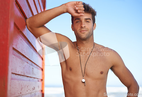 Image of Happy man, portrait and lifeguard on beach for security, bay watch or outdoor swimming in health and safety. Face of male person or professional swimmer smile in fitness for patrol at sea or ocean