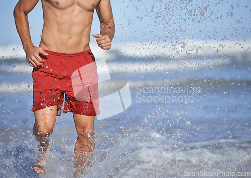 Image of Man, lifeguard and running in water for security, emergency or outdoor swimming in health and safety. Closeup of muscular male person or professional swimmer ready for help or patrol at beach or sea