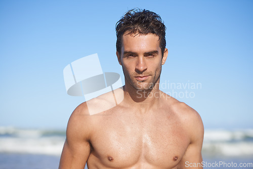 Image of Man, portrait and beach for swimming, workout or outdoor exercise by the ocean coast in summer. Face of muscular male person or professional swimmer for on holiday weekend or vacation by the sea
