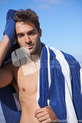 Image of Serious, beach and portrait of man with towel for swimming in ocean on vacation, holiday or adventure. Travel, handsome and young person by sea with confidence for summer weekend trip in Australia.