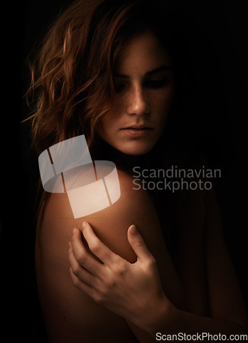 Image of Woman, body and skincare in studio for beauty, dermatology and shadow or light for art deco and aesthetic. Cosmetics model or serious person with self care and creative on a dark or black background