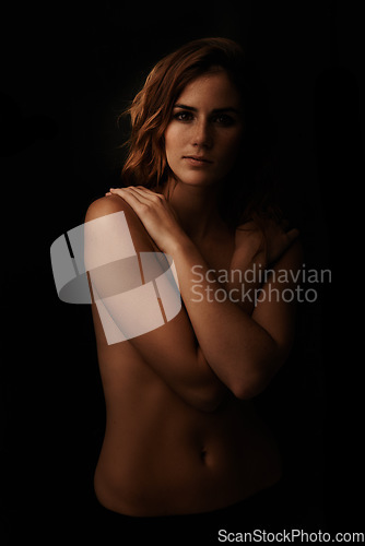 Image of Woman, body and skin care portrait in studio for beauty, dermatology and shadow with light for art deco aesthetic. Cosmetics model or sexy person with glow and self hug on a dark or black background