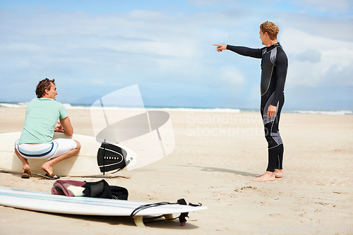 Image of Surfing, beach and men pointing with surfboard for water sports, fitness and exercise by ocean. Nature, friends and people with hand gesture for direction on holiday, vacation and adventure by sea
