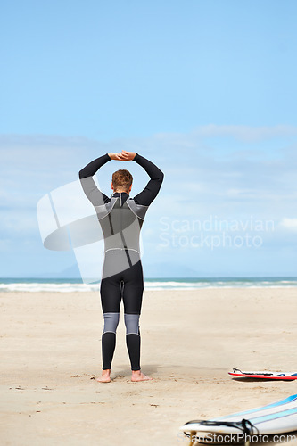 Image of Surfing, stretching and man with surfboard on beach for water sports training, freedom and fitness outdoors. Nature, exercise and person warm up for adventure on holiday, vacation and hobby by sea