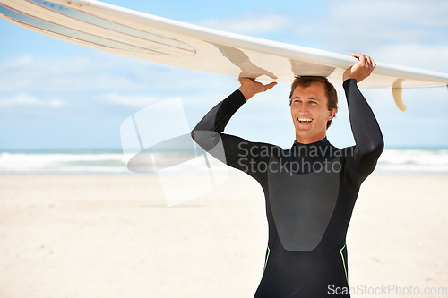 Image of Surfer, man and surfboard at beach for waves, ocean and travel, extreme sports and happy athlete outdoor. Fitness, wellness and summer vacation, nature and surfing on tropical island in Australia