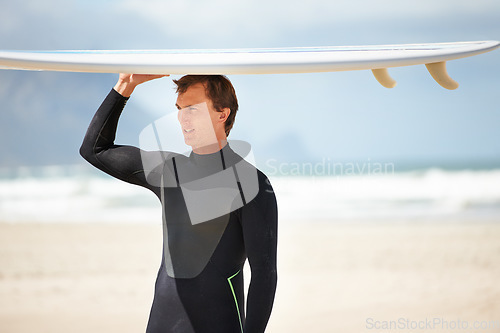 Image of Surfer, man with surfboard and beach for ocean, waves and travel, extreme sports and athlete outdoor with view. Fitness, wellness and summer in nature for surfing on tropical island in Australia