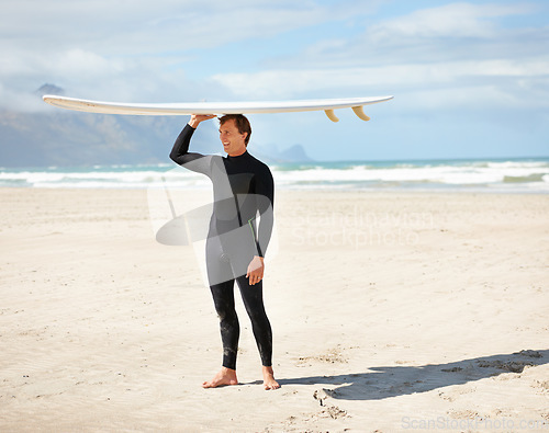Image of Surfing, ocean and man at beach with surfboard on head for water sports training, freedom and fitness outdoors. Nature, happy and person for adventure on holiday, vacation and hobby by sea for waves