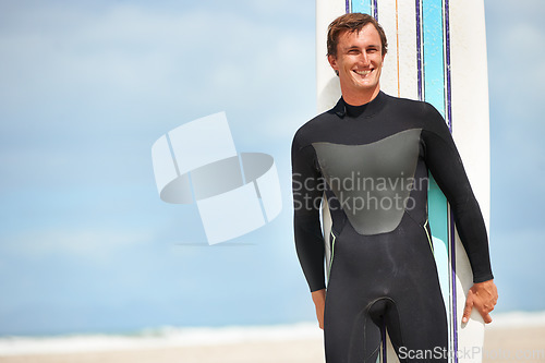 Image of Surfing, sports and man with surfboard on beach for training, freedom and fitness by ocean. Nature, exercise mockup and happy person by sea for adventure on holiday, vacation and hobby in Australia