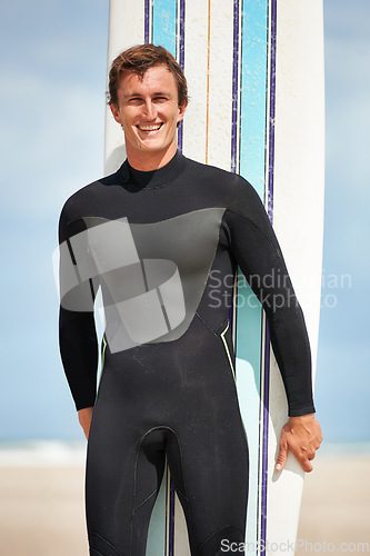 Image of Beach, portrait or happy man with surfboard for exercise, fitness for body health or summer outdoor. Surfer, wetsuit or smile of person by ocean for water sports, travel or holiday vacation in Hawaii