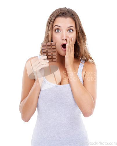 Image of Woman, shocked and portrait with chocolate, candy and sweet tooth with surprise for craving sugar in studio. Hungry, snack and meal for comfort, dessert and sweets for calories, diet and wow