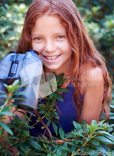 Image of Nature portrait, binocular and child smile for travel adventure, outdoor exploration or bird watching trip. Smile, tree leaves and face of kid on search journey in green forest, woods or eco jungle