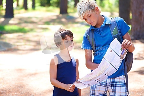 Image of Children, boys with map and hiking in forest, backpack for adventure and exploring nature together. Navigation, search with friends or brothers outdoor, location for travel and trekking through woods