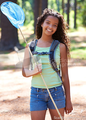 Image of Girl, kid and butterfly net in forest for adventure and hiking outdoor, smile in portrait and backpacking. Travel, young explorer and happy in environment for trekking and explore nature for insects