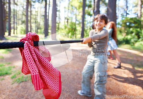 Image of Kids, game and tug of war in forest at summer camp and holiday with travel and energy outdoor. Children with rope, adventure and team building with fun contest, playful and young friends in a park