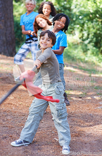 Image of Children, forest and tug of war for play adventure, challenge and strength game in woods with summer camping. Kids, diversity or competitive in outdoor environment for fresh air or happiness by trees