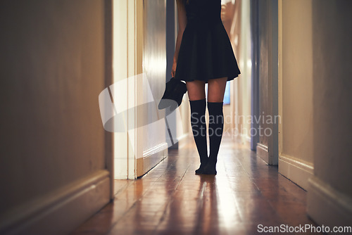 Image of Woman, legs and walking with shoes in hallway for fashion, clothing or outing at home. Closeup of young female person in dress and leggings by door for sneaking, silence or quiet foot steps at house