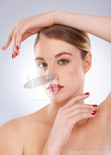 Image of Woman, portrait and skincare in studio with red lipstick for cosmetics, beauty and aesthetic with nail polish. Model, person and confidence with makeup, glowing face and wellness on white background