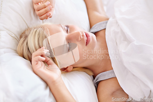 Image of Peace, sleeping and tired woman in a bed resting, dreaming and comfortable in her home. Eyes closed, face and female person asleep in a bedroom with vacation, holiday or snooze on day off in a house