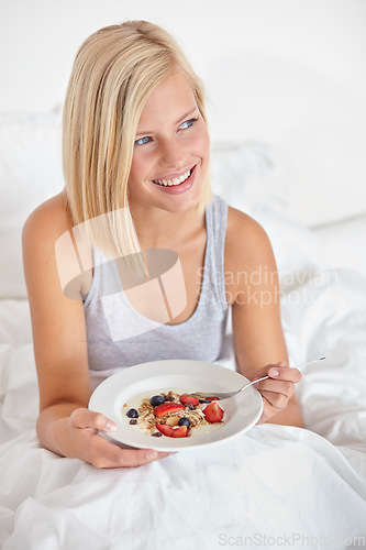 Image of Woman, smile and breakfast in bedroom, hotel and wake up for morning hospitality or accommodation. Relax, food and holiday with happy young person in bed of home, weekend and comfortable with cereal