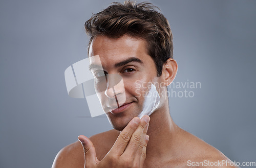 Image of Portrait, shave cream and man with skincare, cosmetics and beauty on a grey studio background. Face, person and model with grooming routine and treatment with beard and moisture with wellness