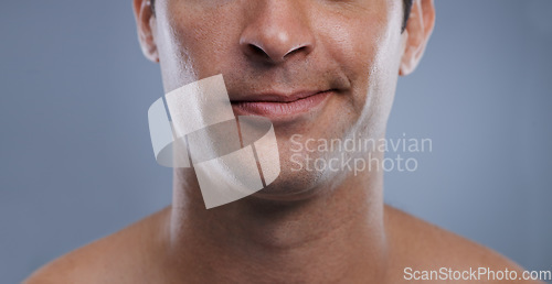 Image of Man, mouth and smirk with face and lips for hygiene, jawline, and unhappy for treatment closeup. Grooming, mockup space and skincare with male model in studio background for clean cosmetics zoom