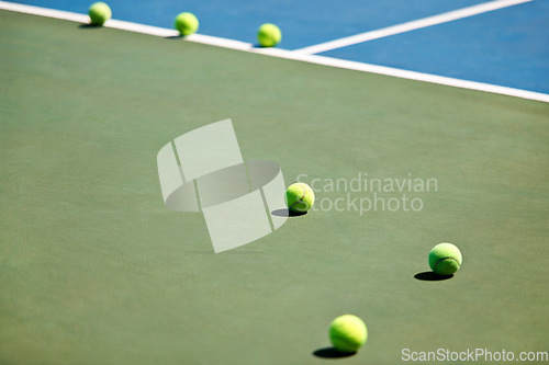 Image of Sport, fitness or tennis balls on court for training, exercise or competitive match to start in summer. Green, background or floor for health or hobby with equipment on the ground ready for a game