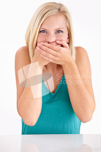 Image of Woman, gossip and cover mouth in portrait with funny, surprise and announcement in studio on white background. Wow, shocked and girl with hands on face for crazy fake news, secret or story of drama