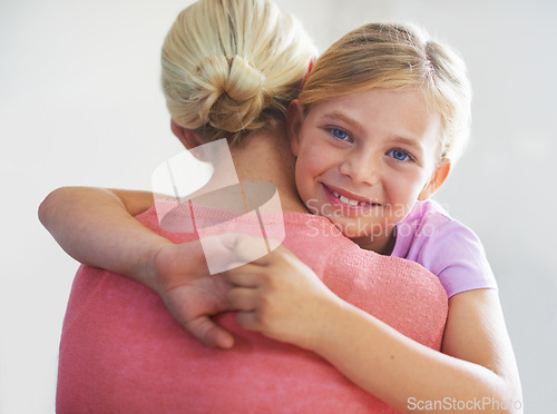 Image of Mother, girl and hug in portrait, bonding and love in childhood by single parent in studio. Daughter, mommy and caring together on white background, embracing and security or enjoying connection