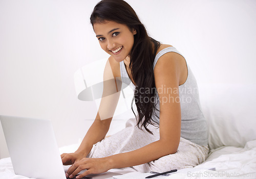 Image of Portrait, home and woman with a laptop, bedroom and typing with internet, technology and connection. Face, person and girl with network, relax and website information with copywriter and digital app