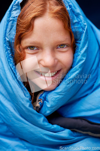 Image of Sleeping bag, camping and portrait of child in tent for rest, relax and comfortable in gear. Travel, youth and face of ginger girl in sleep sack for adventure on holiday, vacation or weekend outdoors