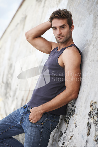 Image of Fashion, outdoor and portrait of man by wall in trendy clothes, casual style and outfit in nature. Brazil, serious and attractive person with confidence, pride and stylish on weekend outdoors