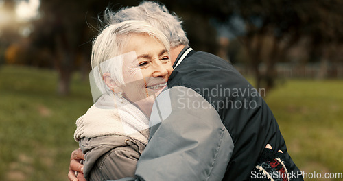 Image of Love, nature and smile with a senior couple hugging outdoor in a park together for a romantic date during retirement. Happy, support and an elderly man and woman bonding in a garden for romance