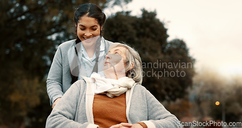 Image of Senior woman, talking and outdoor with caregiver, nurse or healthcare service for person with a disability and wheelchair. Happy, face and elderly lady in park with care and support in retirement