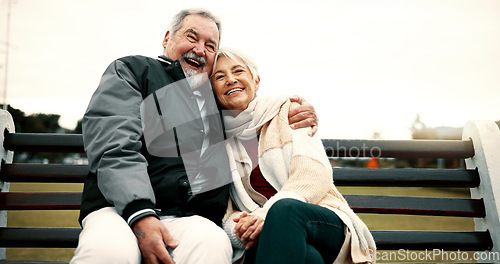 Image of Hug, bench and senior couple on bench at park with love to relax with quality time or care. Retirement, support and elderly man or woman in nature with embrace or laugh in outdoor with bonding.